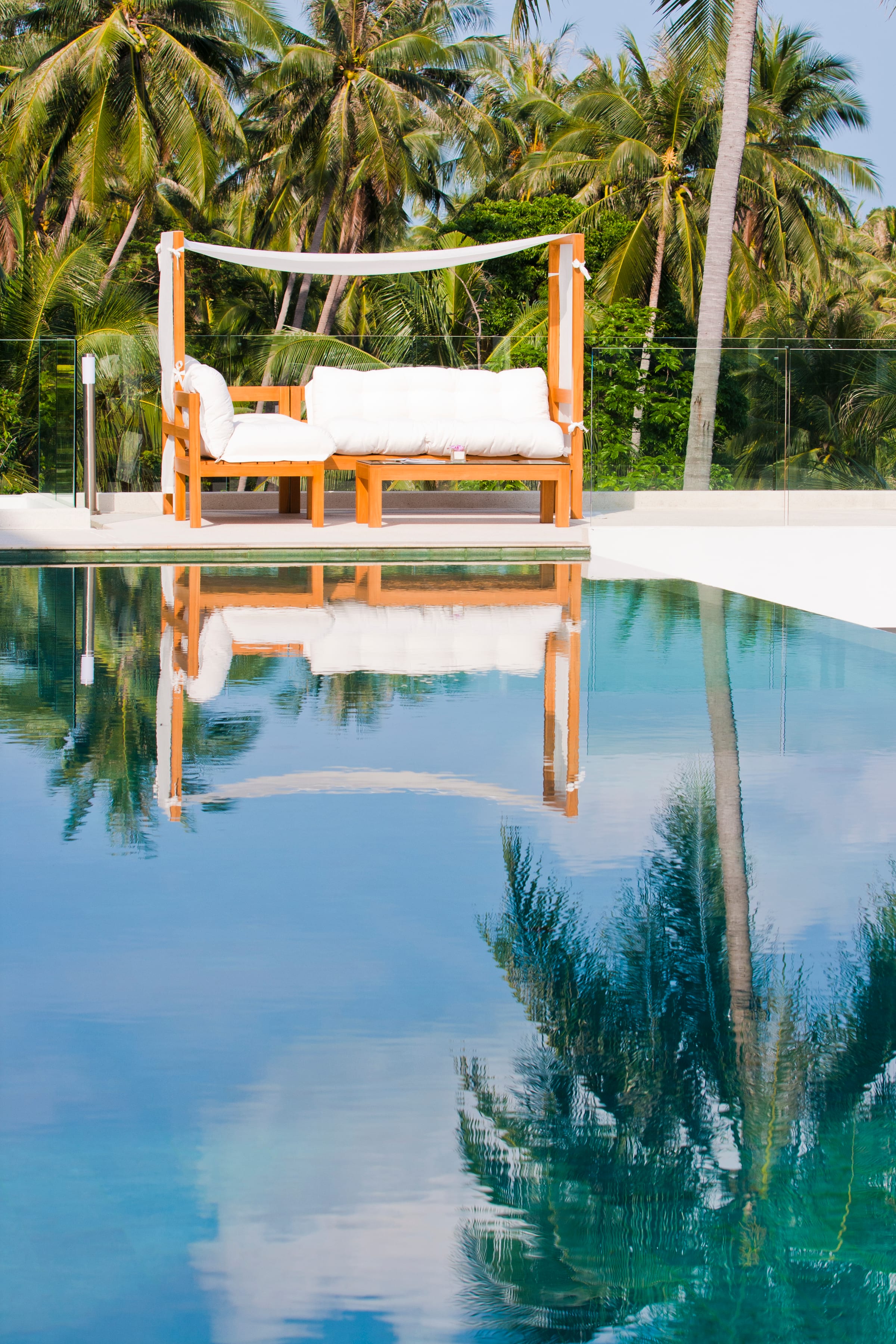 Daybed reflected in the still pool