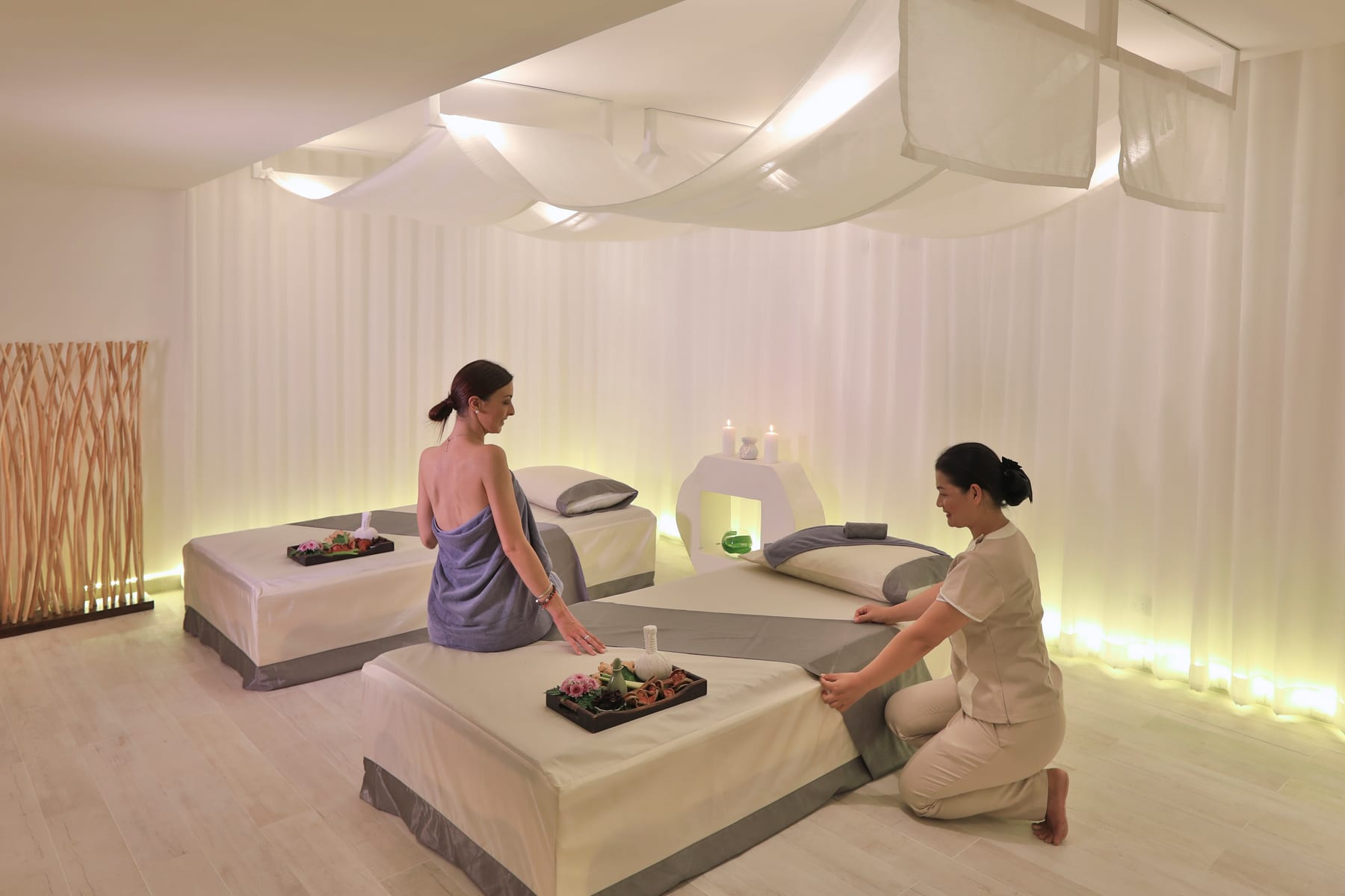 A therapist preparing a treatment room
